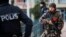 TURKEY -- A Turkish special police officer patrols a mosque during the funeral procession for two victims killed on a rocket attack Wednesday night, in the town of Kilis, Turkey, near the border with Syria, Thursday, Jan. 25, 2018.