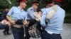 Kazakhstan - Police officers detain a woman during an opposition rally held by critics of Kazakh President Kassym-Jomart Tokayev, who protest over his election in Almaty, Kazakhstan June 12, 2019. REUTERS/Pavel Mikheyev