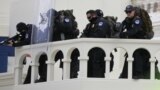 Washington, U.S. - U.S. Capitol Police are seen with "less lethal" weapons as they face a mob of supporters of U.S. President Donald Trump as they storm the U.S. Capitol Building