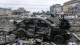 UKRAINE – A damaged car sits at the central square following shelling of the City Hall building in Kharkiv, March 1, 2022
