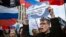 RUSSIA -- A man shots holding a poster reads "internet is our only chance" during the Free Internet rally in response to a bill making its way through parliament calling for all internet traffic to be routed through servers in Russia, in Moscow, March 10,