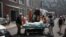 A woman is evacuated from Ohmatdyt Children's Hospital after it was damaged  Russian missile strikes, in Kyiv