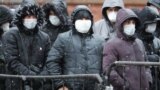 RUSSIA -- Migrants labors stand in line at a migration control center to ask for extension their work permits in Russia during the COVID-19 coronavirus pandemic, in St. Petersburg, April 2, 2020