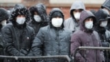 RUSSIA -- Migrants labors stand in line at a migration control center to ask for extension their work permits in Russia during the COVID-19 coronavirus pandemic, in St. Petersburg, April 2, 2020