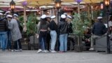 SWEDEN PANDEMIC CORONAVIRUS COVID19 -- Senior high school students celebrate their graduation wearing the traditional white caps while drinking on the terrace of a restaurant in downtown Stockholm, Sweden, 24 April 2020