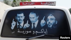 Рисунок на машине, на котором изображены президент Сирии Башар Асад, президент РФ Владимир Путин и лидер "Хезболлы" Сайед Насралла. Латакия, Сирия, май 2014 года 