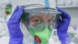 A medical specialist puts on personal protective equipment in Moscow's RZD-Medicine Central Clinical Hospital, which treats coronavirus patients. 