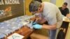 ARGENTINE -- A police officer opens up a package of cocaine found in an annex building Russian embassy in Buenos Aires, December 14, 2016