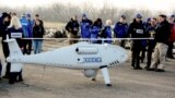UKRAINE -- Members of the Organization for OSCE Mission, Special Monitoring Mission in Ukraine, arrive for the test flight of the unmanned aerial vehicle Camcopter S-100 along the eastern front line near the village of Stepanivka in the Donetsk r