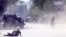 AFGHANISTAN -- A security force and a civilian lie low at the site of a suicide attack after the second bombing in Kabul, Afghanistan, Monday, April 30, 2018.