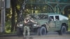 Armored military vehicles carrying armed men in camouflage were seen in Minsk toward the close of voting on August 9, 2020. 