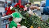 RUSSIA - A woman lays flowers near a school after a shooting in Kazan, Russia, Tuesday, May 11, 2021