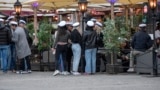 SWEDEN PANDEMIC CORONAVIRUS COVID19 -- Senior high school students celebrate their graduation wearing the traditional white caps while drinking on the terrace of a restaurant in downtown Stockholm, Sweden, 24 April 2020