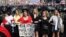BELARUS – Women hold a poster reading "We are not rats, we are Belarusians, you (Lukashenko) run!" as they stand in front of riot police line blocking Belarusian opposition supporters rally in the center of Minsk, August 30, 2020