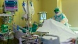 RUSSIA -- A medic wearing special suit to protect against coronavirus treats a patient with coronavirus at the City hospital No. 52 for coronavirus patients in Moscow, June 17, 2021