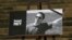 FRANCE -- The portrait of slain teacher Samuel Paty with a black ribbon is displayed on the steps of the National Assembly in Paris, October20, 2020