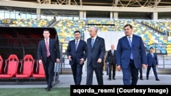 Касым-Жомарт Токаев на новом стадионе в Кызылорде. Справа от него — соучредитель "ВД Строй-инжиниринг" Еркин Окасов. 30 октября 2025 года