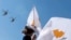 Cyprus -- A child waves the Cypriot national flag as Cypriot AW9 helicopters fly past during a military parade marking the 59th anniversary of Cyprus' independence from British colonial rule, in the capital Nicosia on October 1, 2019