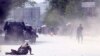 AFGHANISTAN -- A security force and a civilian lie low at the site of a suicide attack after the second bombing in Kabul, Afghanistan, Monday, April 30, 2018.