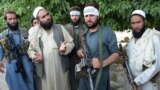 Afghanistan -- Taliban militants stand with residents as they took to the street to celebrate cease-fire on the second day of Eid in the outskirts of Jalalabad, 16June2018