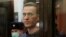 RUSSIA -- A still image taken from video footage shows Russian opposition leader Alexei Navalny, who is accused of flouting the terms of a suspended sentence for embezzlement, inside a defendant dock during the announcement of a court verdict in Moscow, R