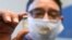 HUNGARY -- A vial containing Russian vaccine Sputnik V is shown by the rector of Semmelweis University Bela Merkely after he was vaccinated at the COVID-19 vaccination site of Semmelweis University in Budapest, February 18, 2021