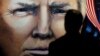 Maryland, U.S. - An attendee at the Conservative Political Action Conference (CPAC) looks at a painting of U.S. Donald Trump in an exhibition hall at National Harbor in Oxon Hill, Maryland, U.S., February 28, 2019. REUTERS/Kevin Lamarque