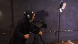 AFGHANISTAN -- An Afghan camerawoman adjusts her camera as she filming a programme for the Zan TV (Women's TV) station in Kabul, January 29, 2019