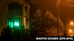 A green light shines in the window of a house in the city of Michalowo, near the Polish-Belarusian border, where an initiative encourages inhabitants to display a green light if they are willing to help migrants in search of food or refuge.