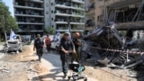 ISRAEL/A rescue personnel carries Tess, a dog rescued from a building that was hit following missile attack from Iran, in Ramat Gan, Israel