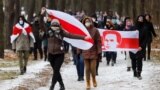 BELARUS-Opposition supporters carry historical white-red-white flags of Belarus as they attend a rally to reject the presidential election results in Minsk, 13dec2020