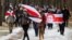 BELARUS-Opposition supporters carry historical white-red-white flags of Belarus as they attend a rally to reject the presidential election results in Minsk, 13dec2020