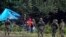 POLAND -- Migrants stuck along the Poland-Belarus border carry plastic water bottles as they are surrounded by Polish forces in Usnarz Gorny, September 1, 2021