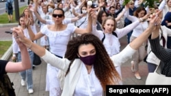 Women dressed in white clothes in Minsk, Belarus on August 12, 2020 protest against police violence during recent rallies against suspected election fraud. 