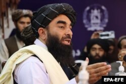 Taliban spokesman Zabihullah Mujahid talks with journalists during a press conference in Kabul on August 17, 2021.