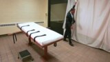 U.S. -- public information director of the Southern Ohio Correctional Facility, demonstrates how a curtain is pulled between the death chamber and witness room at the prison in Lucasville, Ohio. Nov. 2005
