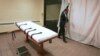 U.S. -- public information director of the Southern Ohio Correctional Facility, demonstrates how a curtain is pulled between the death chamber and witness room at the prison in Lucasville, Ohio. Nov. 2005