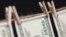 Generic -- Hundred Dollar Bills Hanging From a Clothesline on a Dark Background.