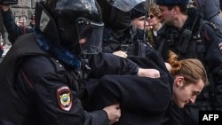 Russian riot police detain a participant in protests in front of the FSB headquarters in Moscow on March 14. 