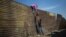 WPP -- Spot News Singles 3rd prize -- Climbing the Border Fence Pedro Pardo, Mexico, Agence France- Presse