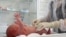 RUSSIA -- A medical specialist wearing protective gear takes care of a newborn baby infected with the coronavirus disease (COVID-19) at a maternity hospital in Volgograd, August 19, 2021