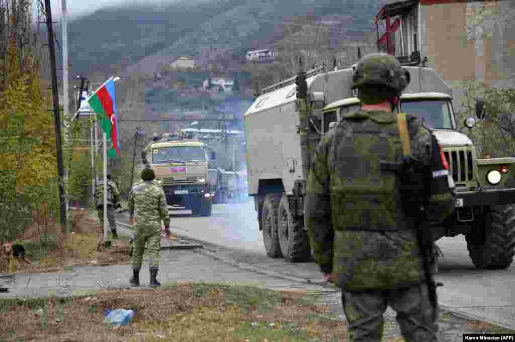 Azerbaijani military trucks move through the town of Lachin (Berdzor) on December 1, 2020. The larger Lachin district is the last of three districts adjoining breakaway Nagorno-Karabakh that Armenia agreed to return to Azerbaijani control under a November 9, 2020 truce.&nbsp;