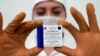 A nurse holds a pack of Russia's Sputnik-V vaccine against COVID-19 during a vaccination in Kaliningrad on December 4, 2020.