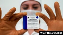 A nurse holds a pack of Russia's Sputnik-V vaccine against COVID-19 during a vaccination in Kaliningrad on December 4, 2020.