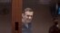 RUSSIA -- Kremlin critic Aleksei Navalny, who is accused of slandering a Russian World War Two veteran, is seen inside a defendant dock during a court hearing in Moscow, February 12, 2021