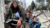 Members of Taliban forces sit at a checkpost in Kabul, Afghanistan