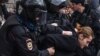 Russian riot police detain a participant in protests in front of the FSB headquarters in Moscow on March 14. 