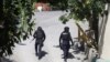 HAITI -- Police officers walk near the private residence of Haiti's President Jovenel Moise after he was shot dead by gunmen with assault rifles, in Port-au-Prince, Haiti July 7, 2021. REUTERS/Estailove St-Val NO RESALES. NO ARCHIVES