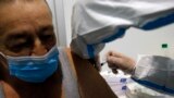 SERBIA -- A medical worker administers a shot of COVID-19 vaccine to a man in Belgrade, February 17, 2021