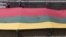 Lithuania -- People carry about 200 meter long sash in Lithuanian flag colours during Day of the Defenders of Freedom celebration in Vilnius, 13Jan2011